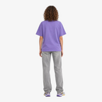 Female model wearing STF lavender boxy oversized T-shirt back view
