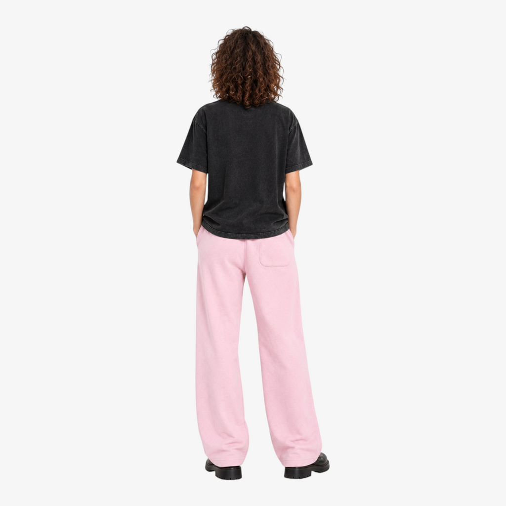 STF No Signal graphic T-shirt in washed black — Female model back with pink wide-leg trousers