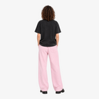 STF No Signal graphic T-shirt in washed black — Female model back with pink wide-leg trousers