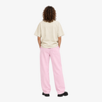STF Statue Graphic T-shirt in cream — Female model back with pink wide-leg trousers