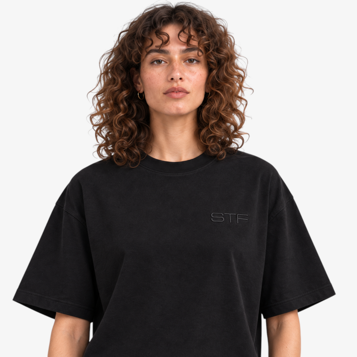 Female model wearing STF black T-shirt tonal embroidery close-up