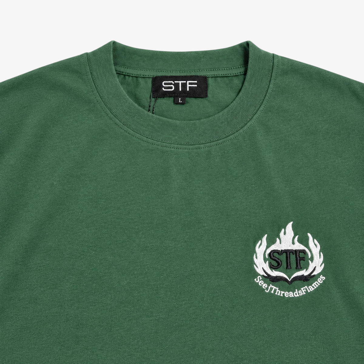 STF forest green T-shirt collar label and flame embroidery detail