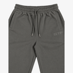 STF grey relaxed open-hem trousers — waistband and embroidery detail