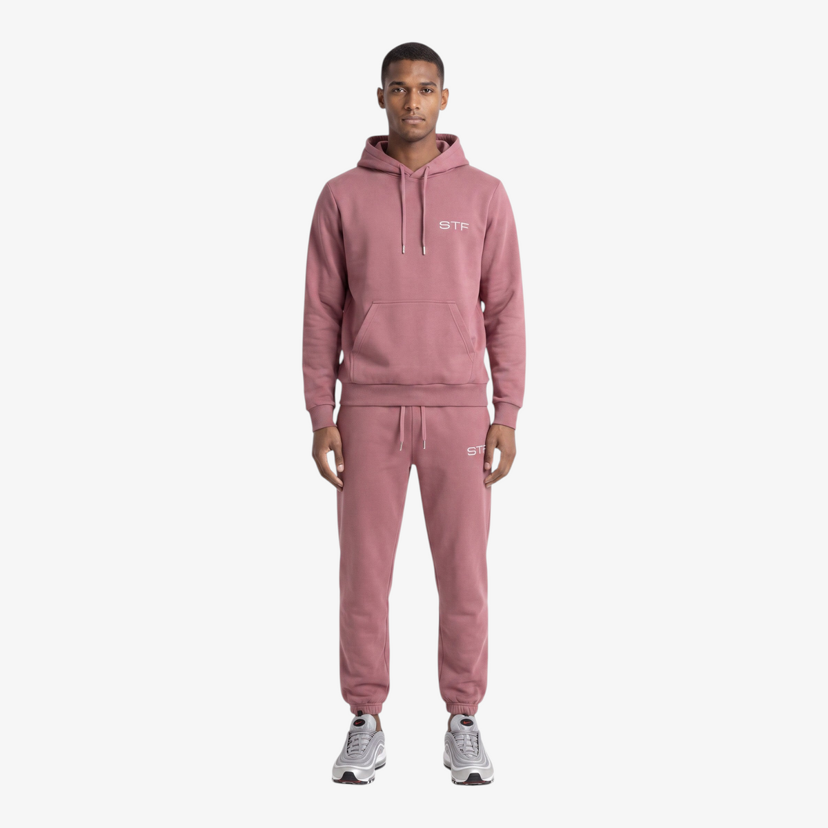 Model wearing a Seejthreadsflames (STF) mauve heavyweight cotton tracksuit with oversized hoodie and relaxed joggers.