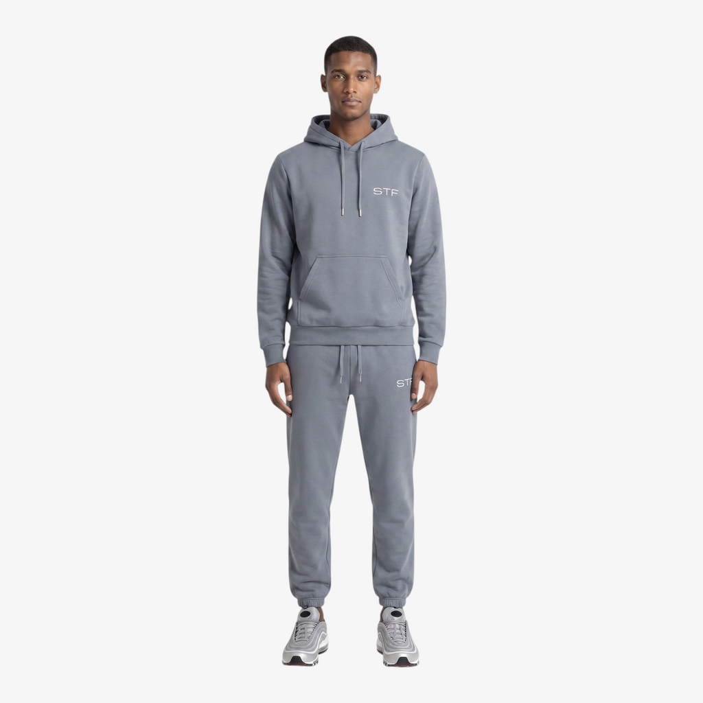 Model wearing Seejthreadsflames (STF) grey heavyweight cotton tracksuit with oversized hoodie and relaxed-fit joggers