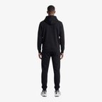 Back view of a man wearing a Seejthreadsflames (STF) black heavyweight cotton tracksuit with an oversized hoodie.