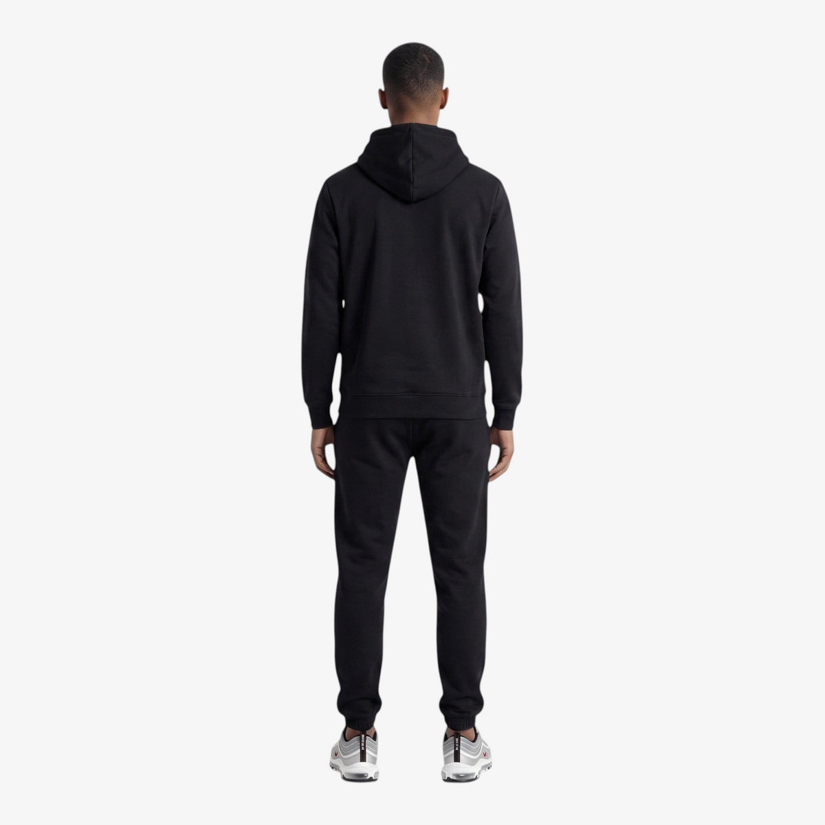 Back view of a man wearing a Seejthreadsflames (STF) black heavyweight cotton tracksuit with an oversized hoodie.