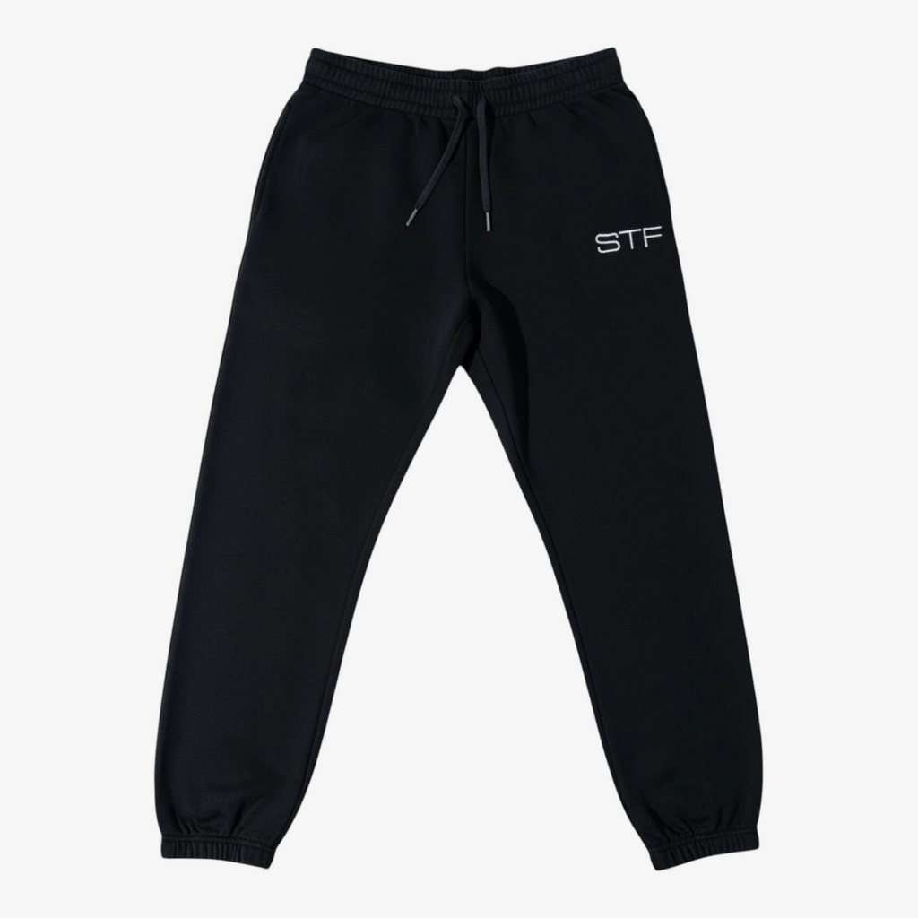 Seejthreadsflames (STF) black French terry joggers with an adjustable drawcord, elastic cuffs, and embroidered logo.